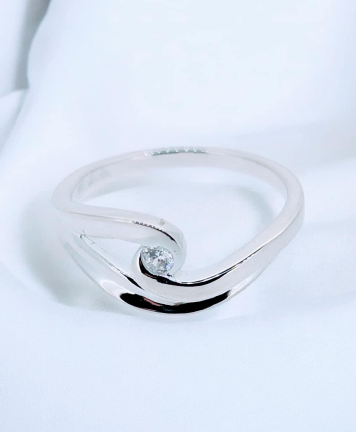 Sterling Silver Breaking Wave Ring - cresting tide cradling a cut zirconia at its peak on this sterling silver ring.