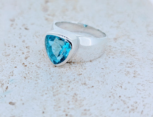 Striking wide-band sterling silver ring, featuring a brilliant Swiss Blue Topaz gemstone